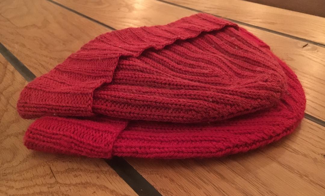 Two Rounded Red Hats. One new, and one worn for over a year around the world.