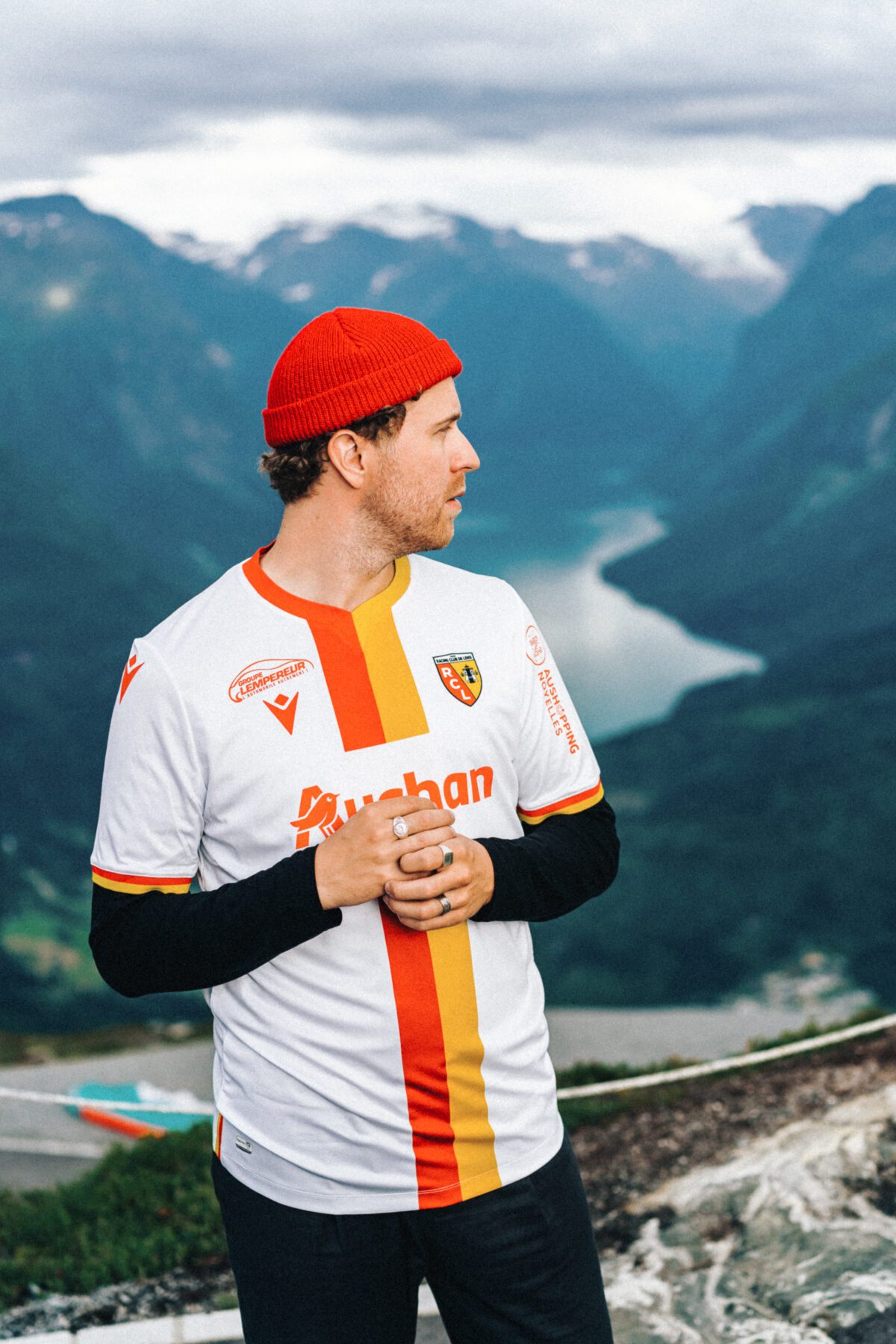 Norwegian musician wearing a red hat in the Mountains