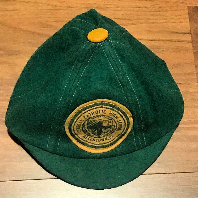 Early American school beanie with small brim.